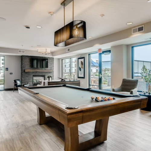 a clubroom with a pool table and chairs
