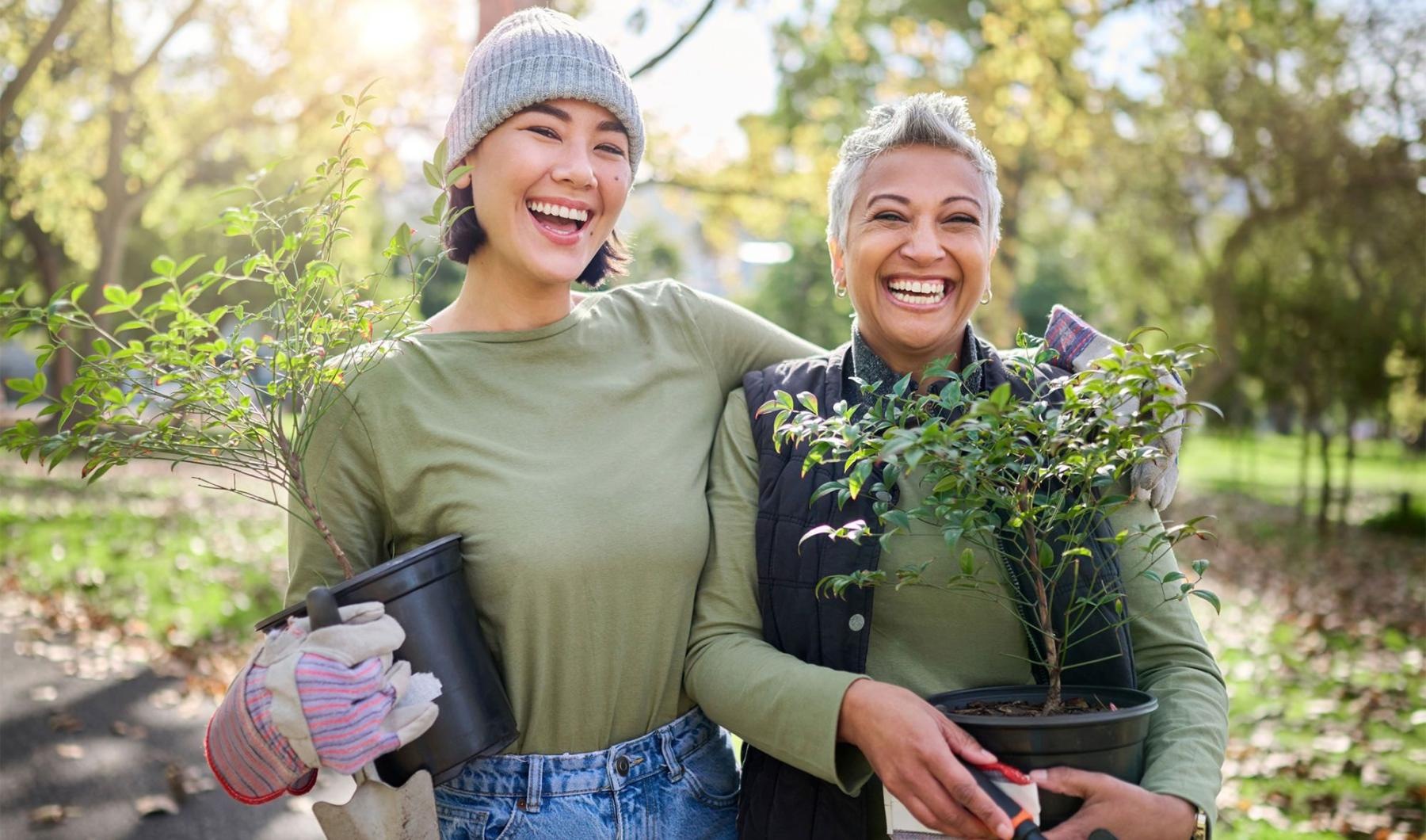 a couple of women holding plants
